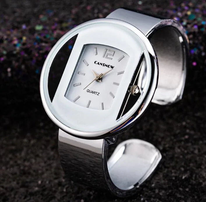 Silver CANSNOW quartz wristwatch with unique open circular design and rectangular dial on black surface