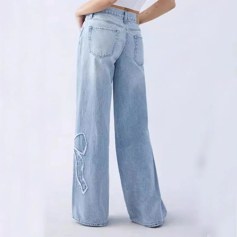 Back view of light blue wide-leg jeans with embroidered R detail on left leg