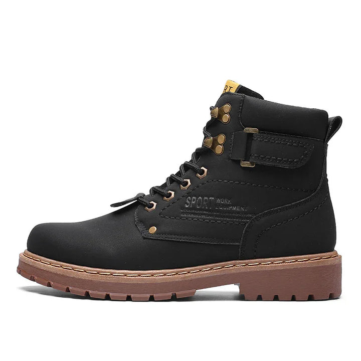Black leather work boot with brown rubber sole, metal eyelets, and ankle strap detail