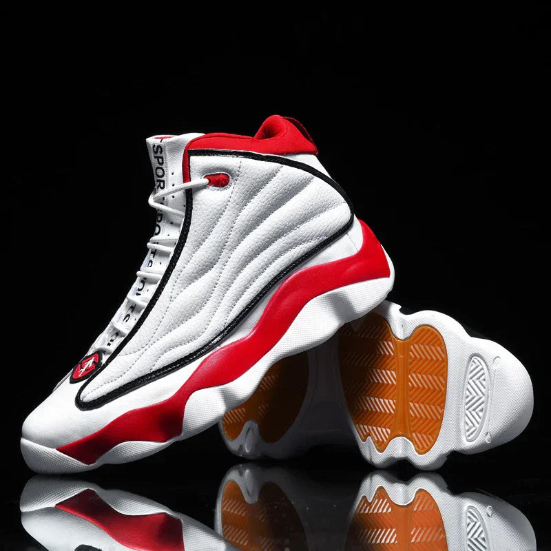 White and red high-top sports sneakers with black accents and textured orange soles on black background