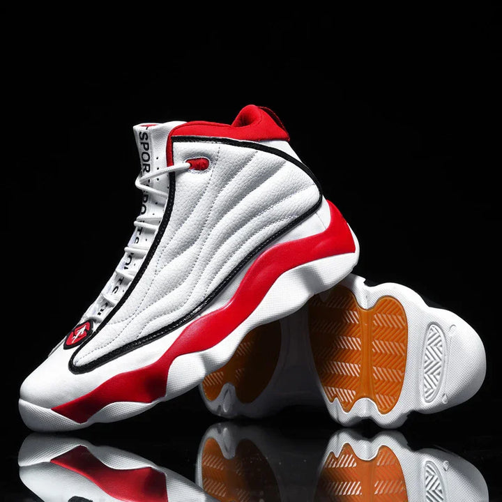 White and red high-top sports sneakers with black accents and textured orange soles on black background