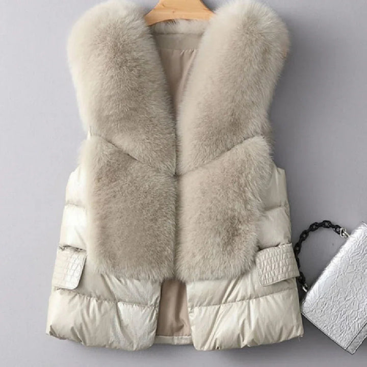 cream sleeveless puffer vest with large soft fur collar on wooden hanger