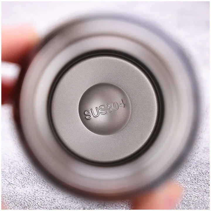 Close-up of stainless steel cup bottom marked SUS304