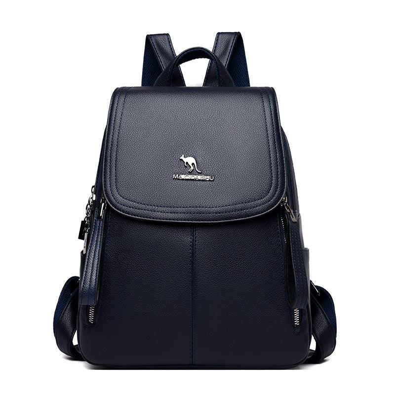 Navy blue leather backpack with front flap and silver kangaroo logo on white background