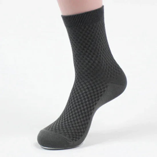 Black textured ankle sock on foot with ribbed cuff, cotton blend fabric