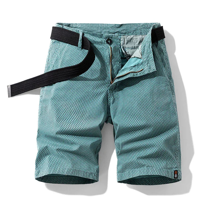 Men's teal textured casual shorts with black belt, zip and button closure on white background