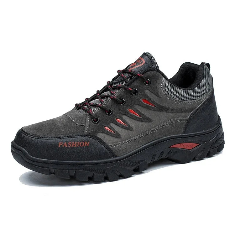 Black and gray fashion sneaker with red accents and rugged sole, lace-up design, breathable mesh collar