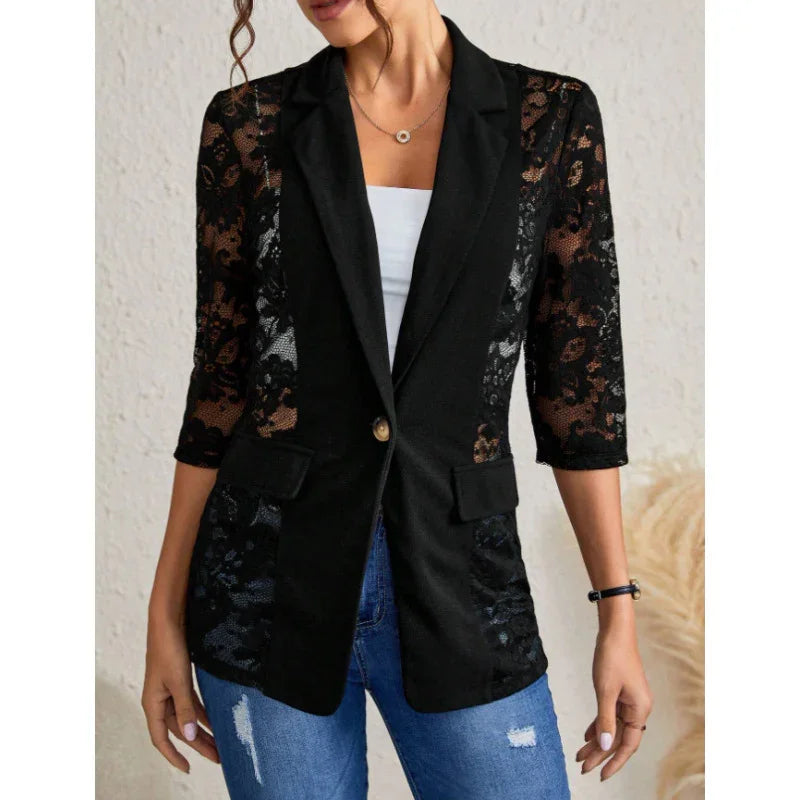 Woman wearing black lace blazer with 3/4 sleeves, white inner top, and ripped blue jeans