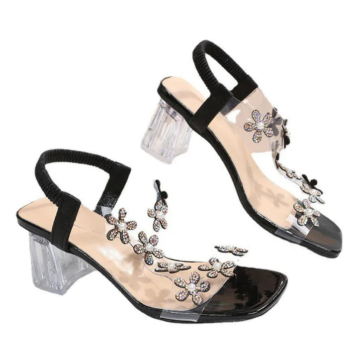 Black open-toe heels with clear block heels and embellished rhinestone flower straps