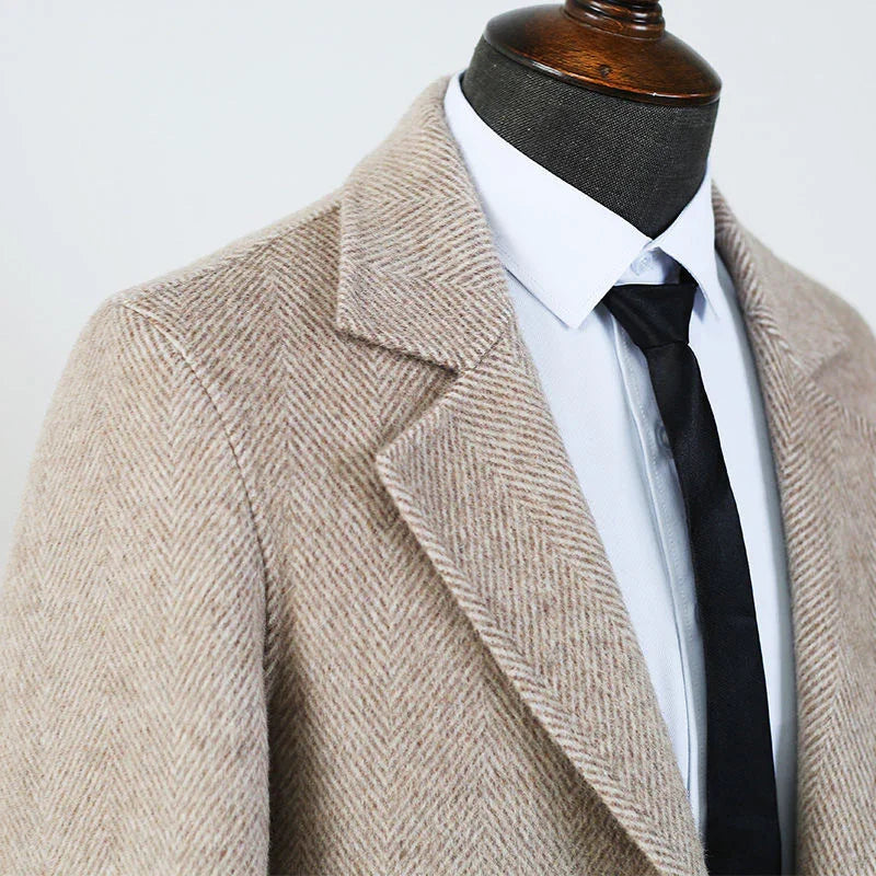 Beige herringbone wool coat on mannequin with white dress shirt and black tie