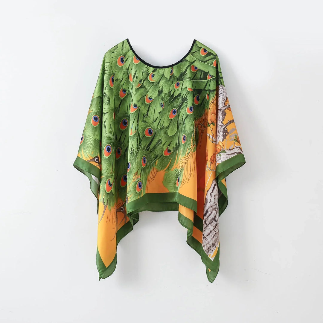 Green and orange silk poncho with peacock feather design and bird illustration