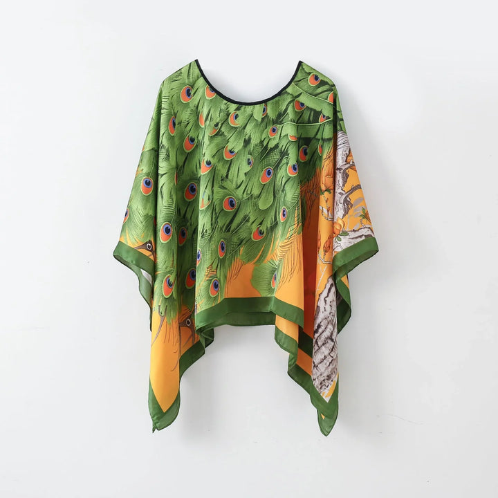 Green and orange silk poncho with peacock feather design and bird illustration