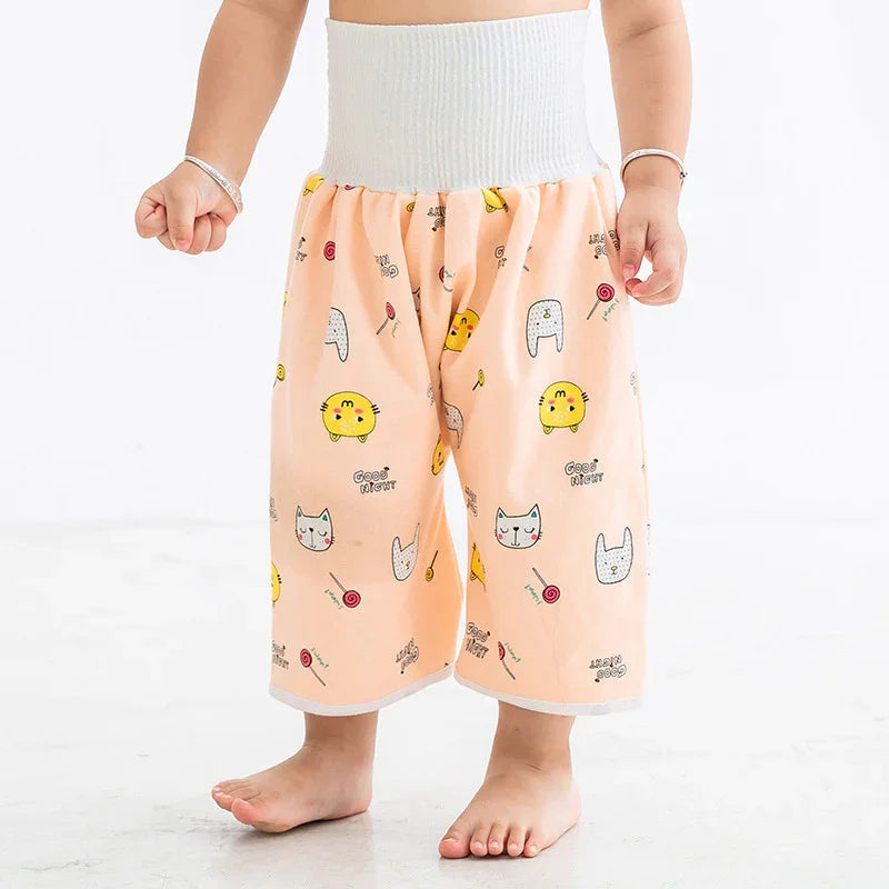 Child wearing peach color wide-leg pants with cat and candy print and white elastic waistband