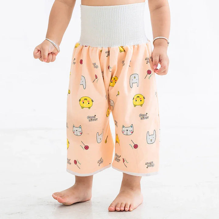 Child wearing peach color wide-leg pants with cat and candy print and white elastic waistband