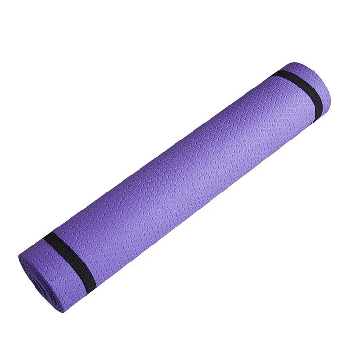 Purple textured yoga mat rolled up with black straps, fitness and exercise accessory