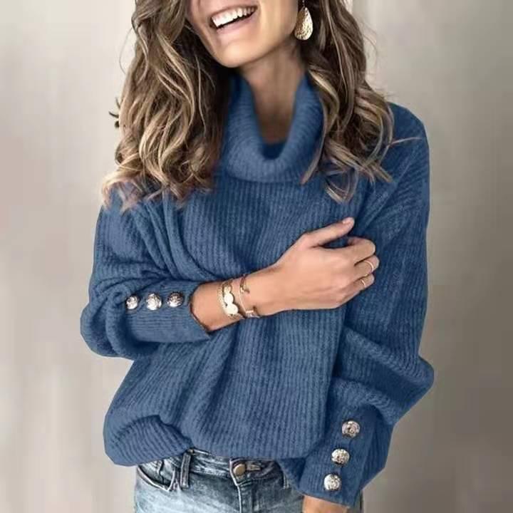 Woman wearing cozy blue turtleneck sweater with decorative buttons on sleeves and light jeans