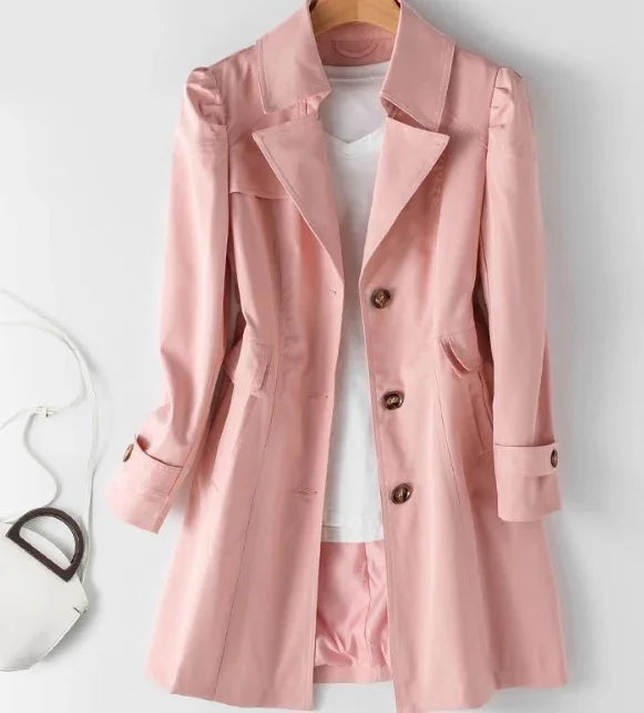 Pink long sleeve trench coat with buttons over white top and matching shorts, displayed on hanger