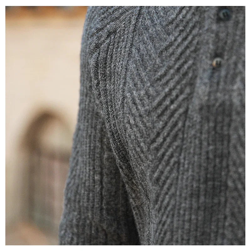 Close-up of gray textured knit sweater with diagonal rib pattern and buttons