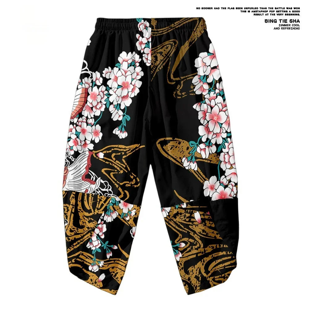 Black elastic waist pants with pink cherry blossoms and gold abstract patterns