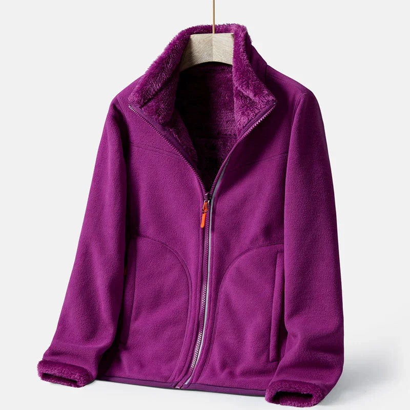 Purple fleece jacket with full zipper and soft lined collar hanging on wooden hanger