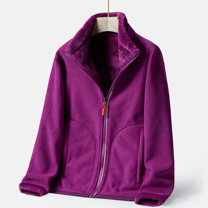 Purple fleece jacket with full zipper and soft lined collar hanging on wooden hanger