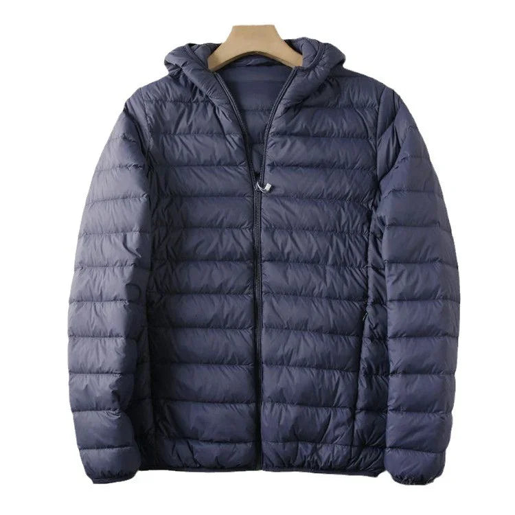 Navy blue lightweight puffer jacket with hood and zipper on wooden hanger