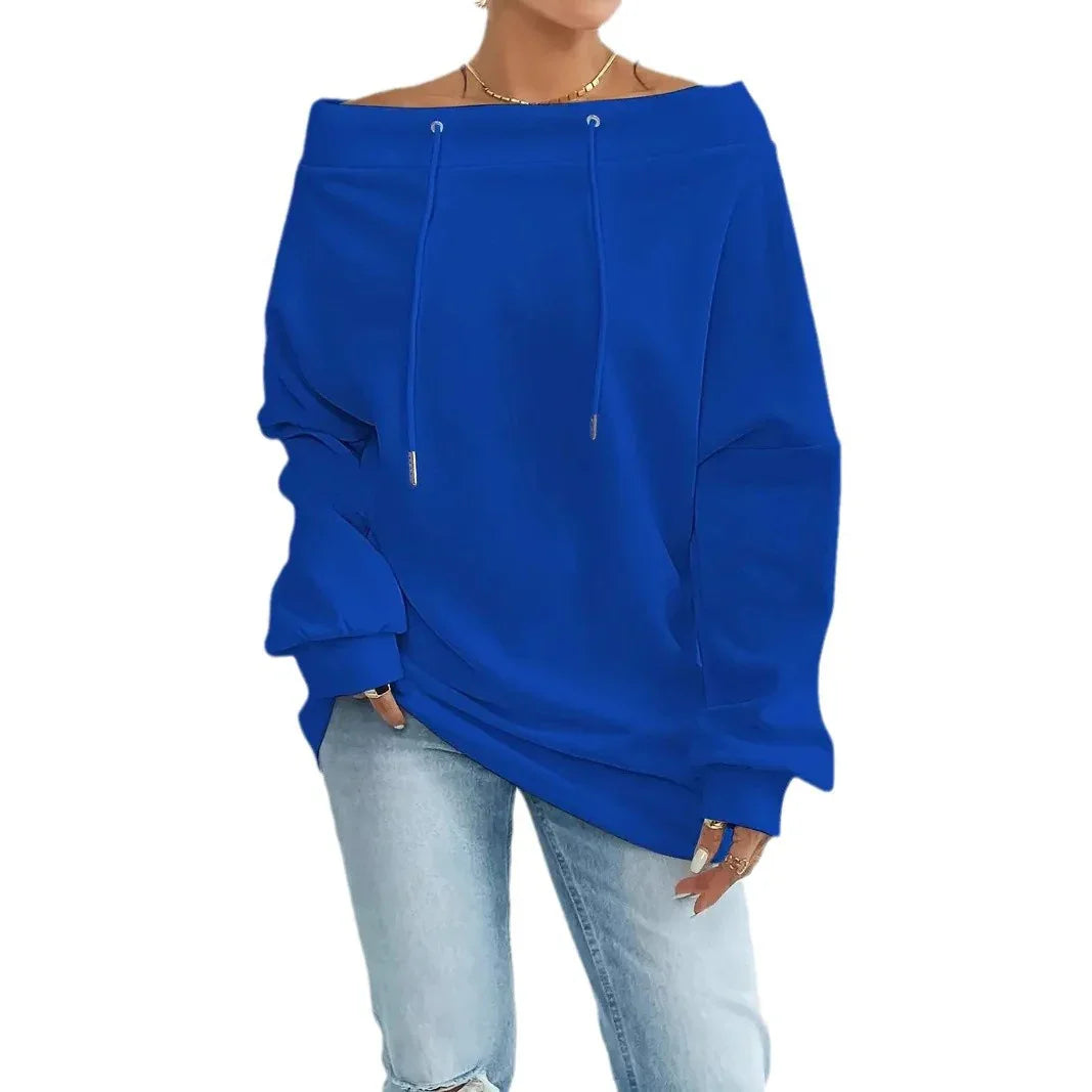 Woman wearing royal blue off-shoulder oversized sweatshirt with drawstrings and light-wash jeans