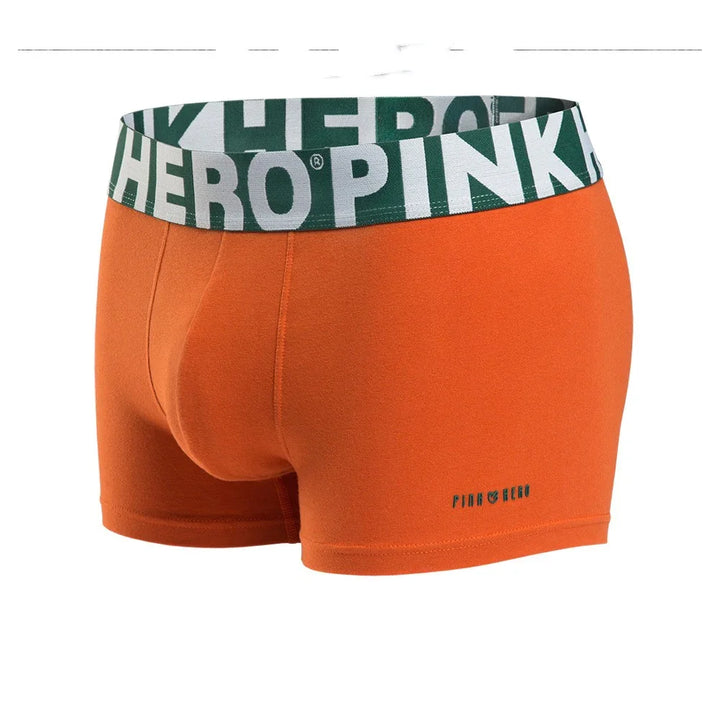 Orange men's boxer briefs with green and white elastic waistband featuring Pink Hero branding