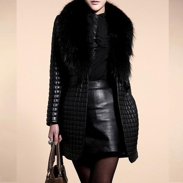 Stylish woman wearing black quilted coat with fur collar and black leather skirt holding brown handbag