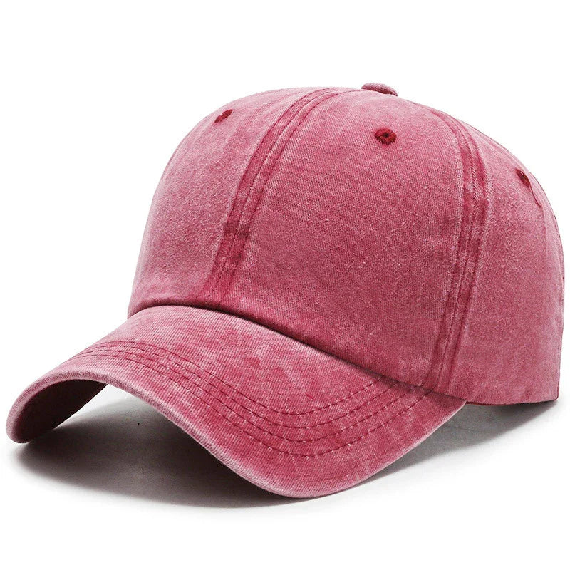 Vintage washed pink baseball cap with curved brim on white background