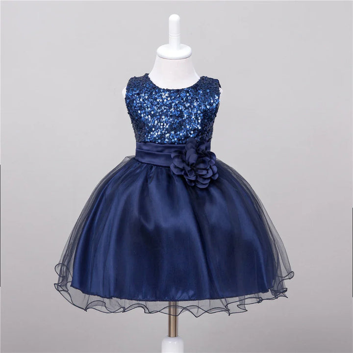 Navy blue sleeveless girl's party dress with sequin bodice and floral sash on mannequin
