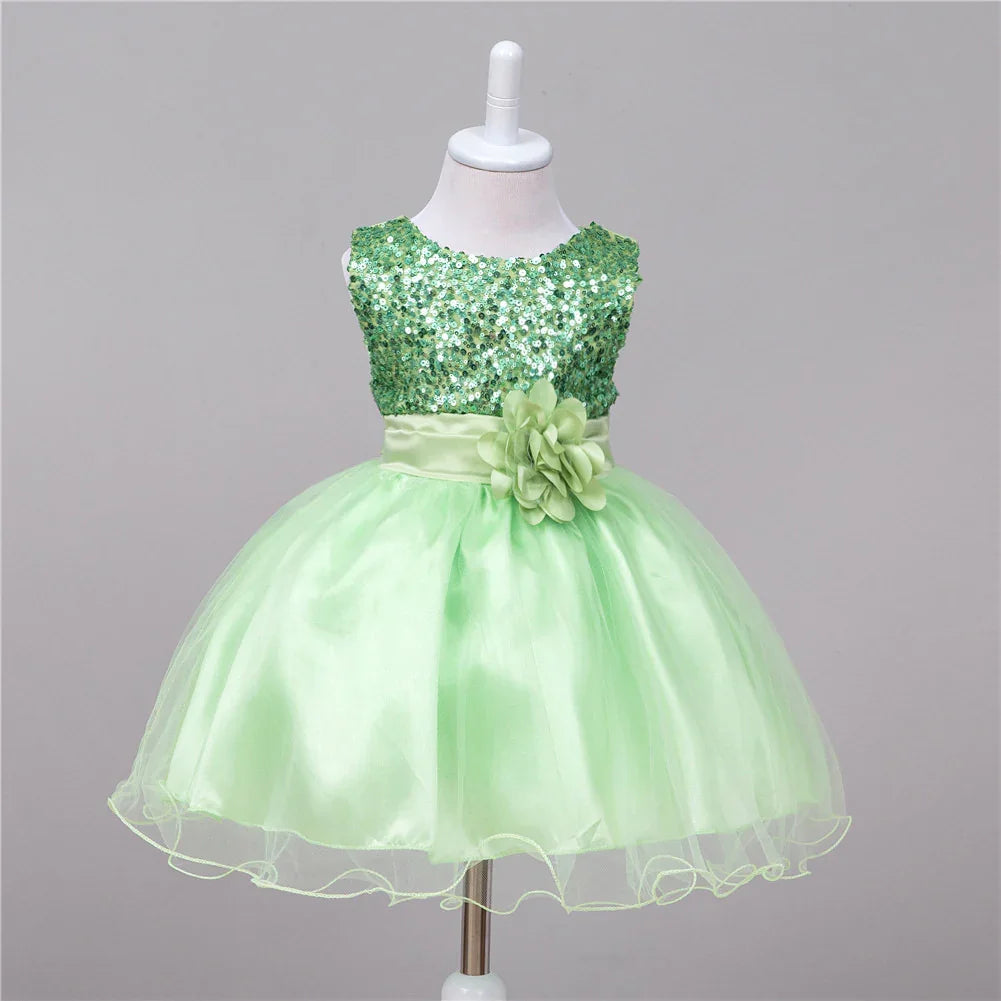 Light green toddler dress with sequin bodice, satin waistband, and tulle skirt on mannequin