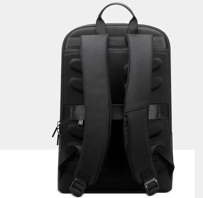 Back view of black backpack with padded adjustable straps and top handle on white background