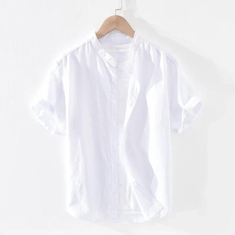 White short sleeve button-up shirt with mandarin collar on wooden hanger