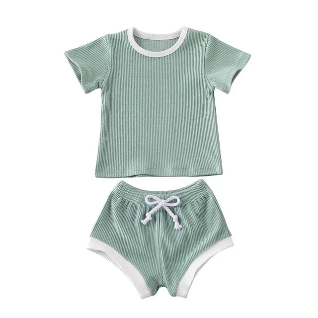 Light green ribbed cotton toddler outfit with white trim, short-sleeve top and drawstring shorts