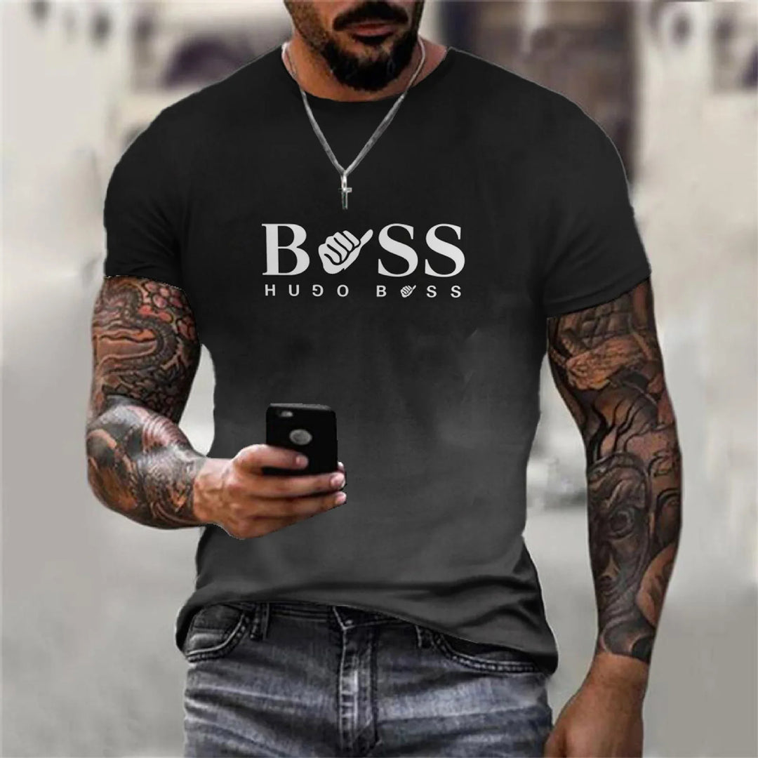 Man with tattooed arms wearing black Hugo Boss t-shirt and holding a smartphone