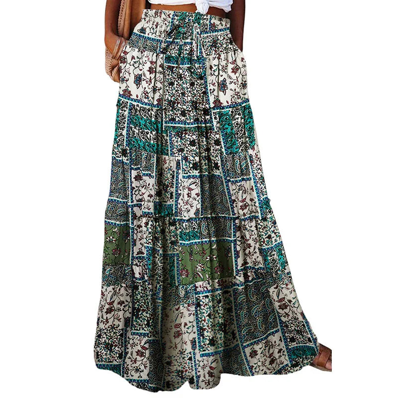Woman wearing a patchwork floral maxi skirt in green, blue, and cream colors with pockets