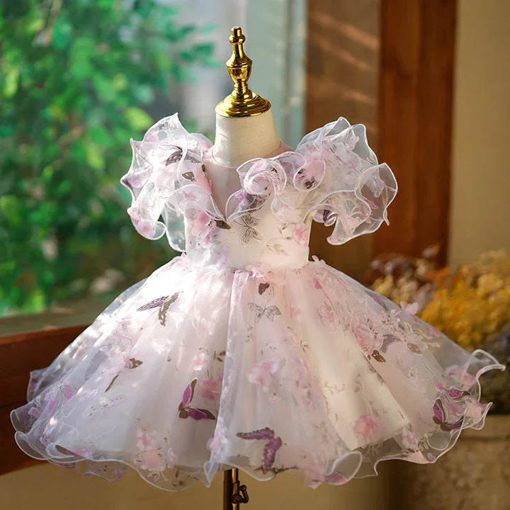 Baby girl butterfly print dress with ruffled organza sleeves on mannequin in natural light