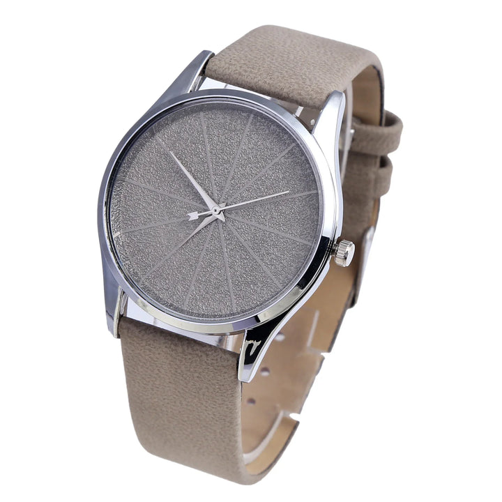 Minimalist silver wristwatch with textured gray dial and beige leather strap