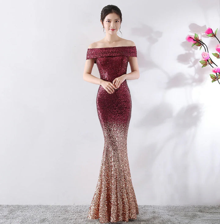 Woman wearing a glittering off-shoulder ombre evening gown in burgundy and gold