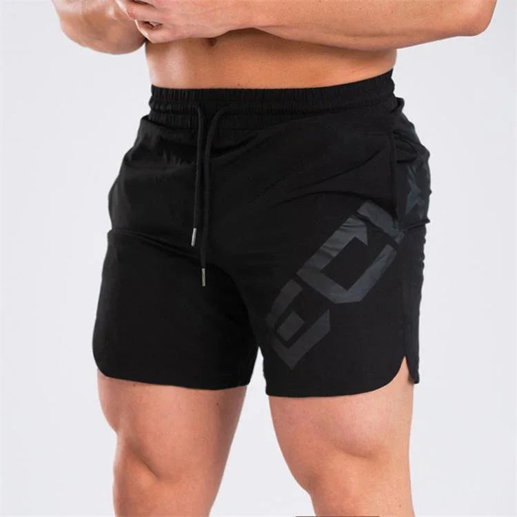 Athletic man wearing black workout shorts with drawstring and geometric logo print