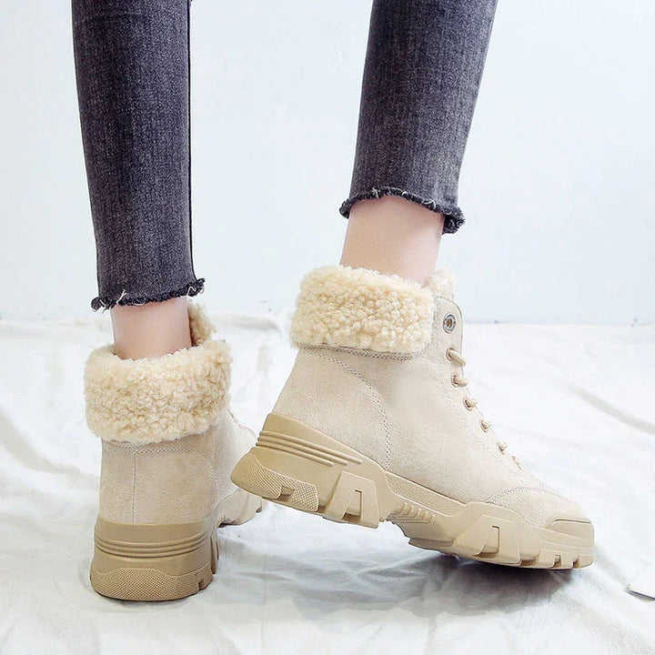 Beige suede ankle boots with fluffy shearling cuffs worn with dark grey frayed hem skinny jeans