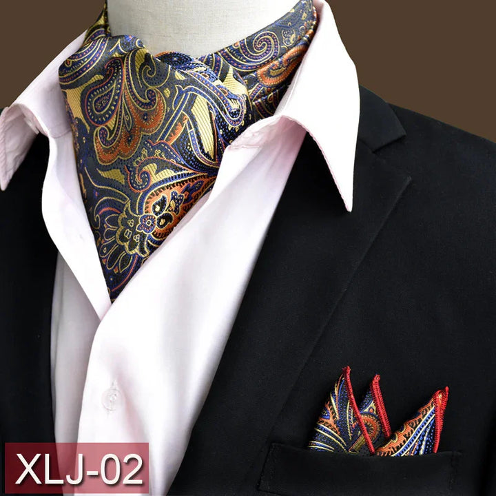 Men's paisley silk ascot scarf in navy, gold with matching pocket square on black blazer and white shirt