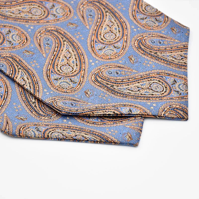 Blue fabric with intricate brown and beige paisley pattern, folded on white background