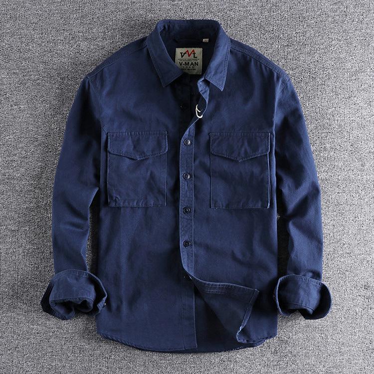 Navy blue casual long-sleeve shirt with button pockets on a gray textured background