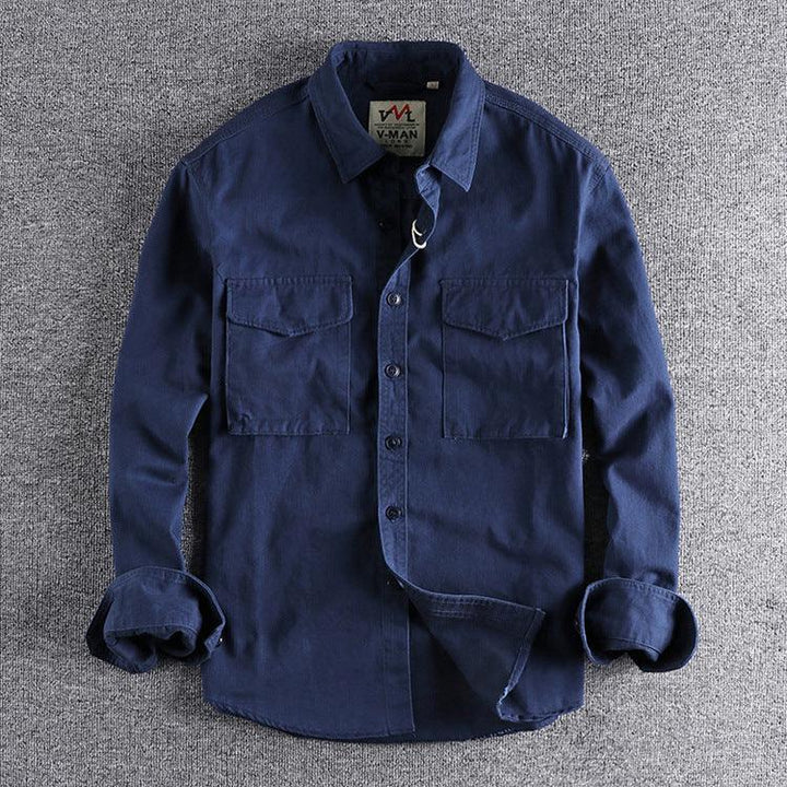 Navy blue casual long-sleeve shirt with button pockets on a gray textured background