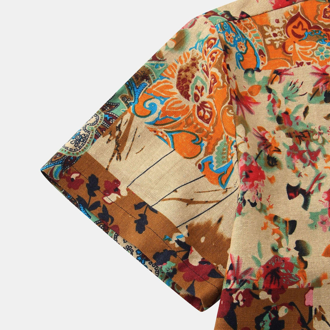 Close-up of a short sleeve with vibrant floral and paisley print in orange, red, blue, and brown tones