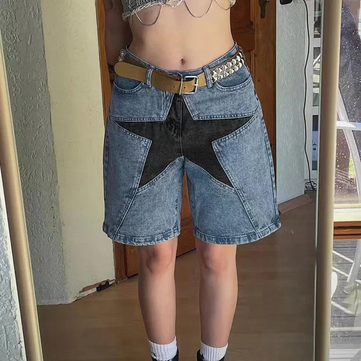Denim shorts with black star design, studded belt, and cropped top in home setting mirror selfie