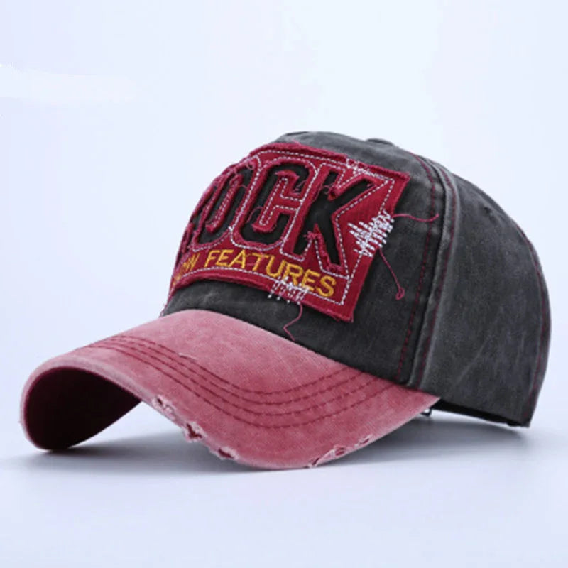 Vintage style baseball cap with distressed pink brim and black crown featuring embroidered red patch reading 'ROCK NEW FEATURES'