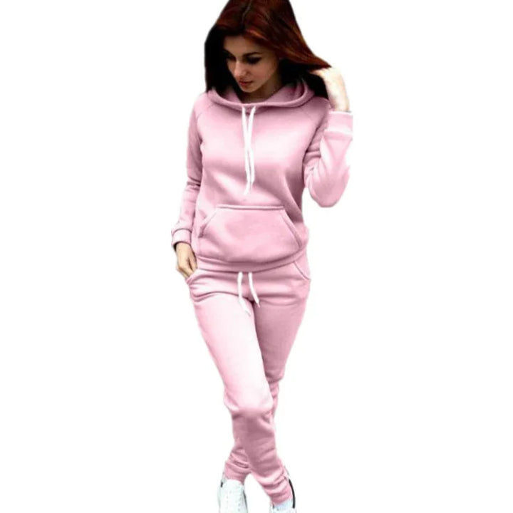 Woman in light pink hoodie and matching sweatpants outfit with white drawstrings, casual athleisure wear